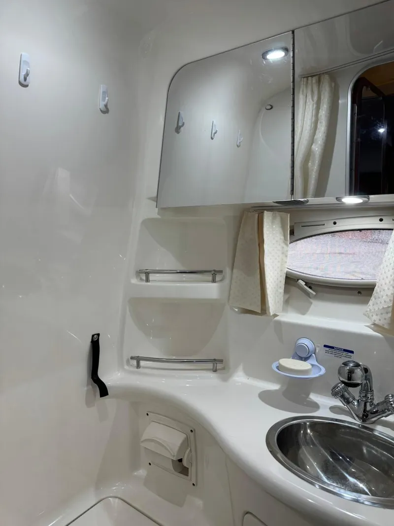 Slide: The Image of 2005 Chaparral Signature 310 bathroom with sink, mirror, and window. - 30