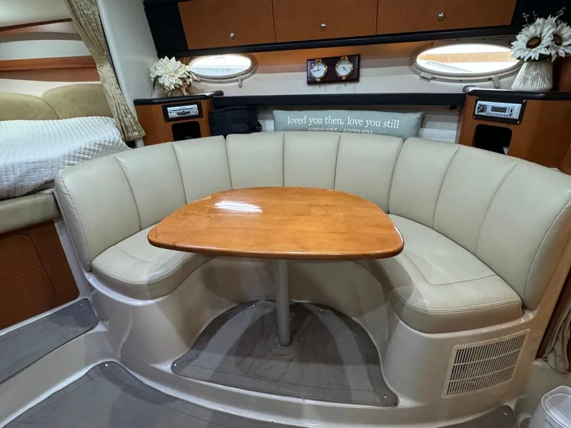 Slide: The Image of 2005 Chaparral Signature 310 interior with beige seating and wooden table. - 31