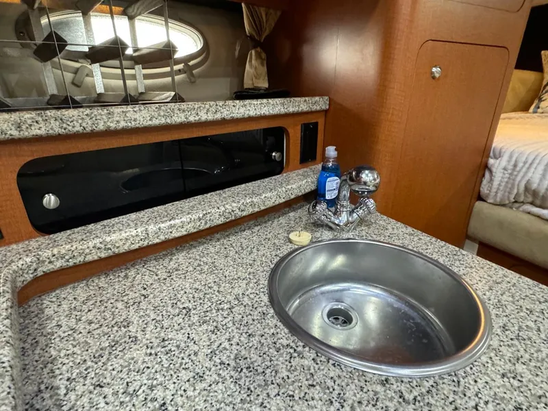 Slide: The Image of 2005 Chaparral Signature 310 boat interior with granite countertop and sink. - 35