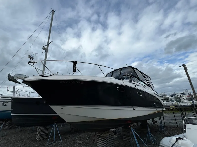 Slide: The Image of 2005 Chaparral Signature 310 boat on stands under cloudy sky. - 4
