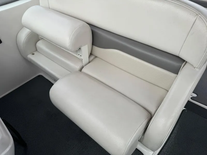 Slide: The Image of 2005 Chaparral Signature 310 boat interior seating, featuring white and gray cushioned seats. - 43