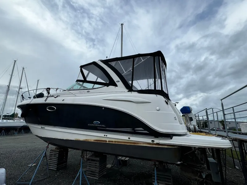 Slide: The Image of 2005 Chaparral Signature 310 boat on stands, overcast sky background. - 5