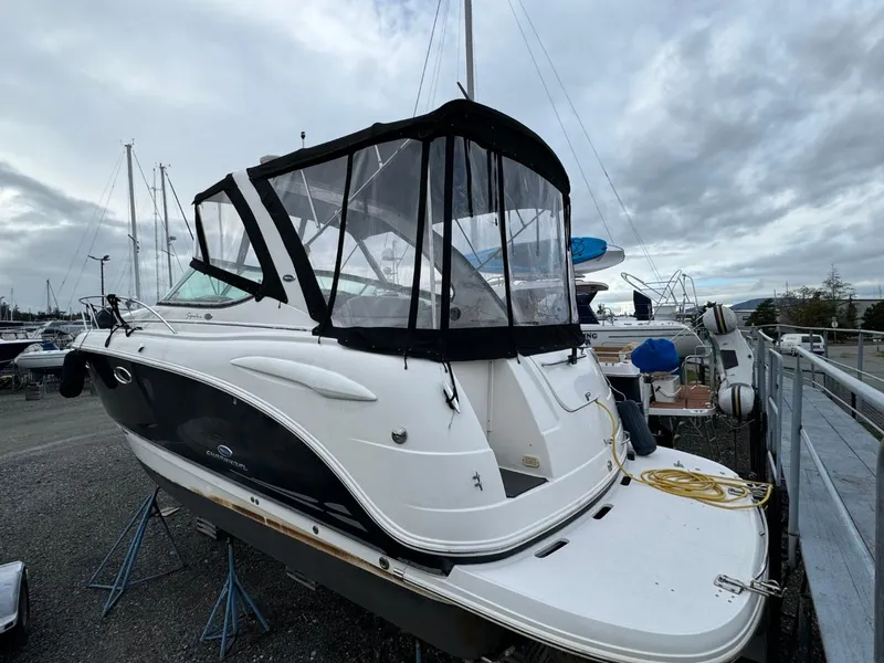 Slide: The Image of 2005 Chaparral Signature 310 boat on stands, marina background, overcast sky. - 6