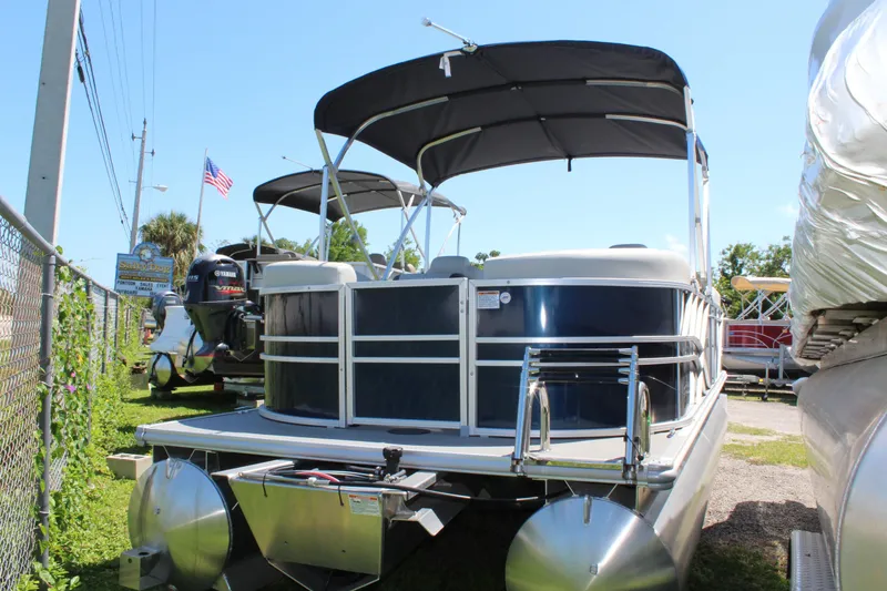 Slide: The Image of 2025 Sylvan Mirage 822 LZ pontoon boat interior with beige seating and helm. - 2
