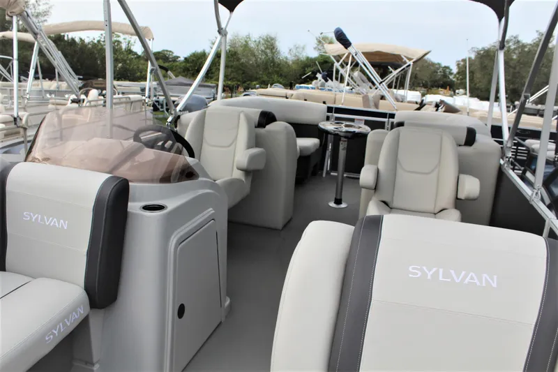 Slide: The Image of Luxurious seating on 2025 Sylvan Mirage 822 LZ pontoon boat, featuring beige upholstery. - 6