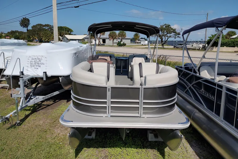 Slide: The Image of 2025 Sylvan Mirage 822 LZ pontoon boat displayed outdoors on a sunny day. - 12