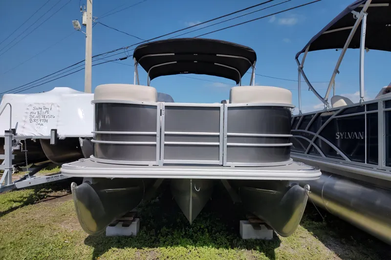 Slide: The Image of 2025 Sylvan Mirage 822 LZ pontoon boat displayed outdoors under clear sky. - 13