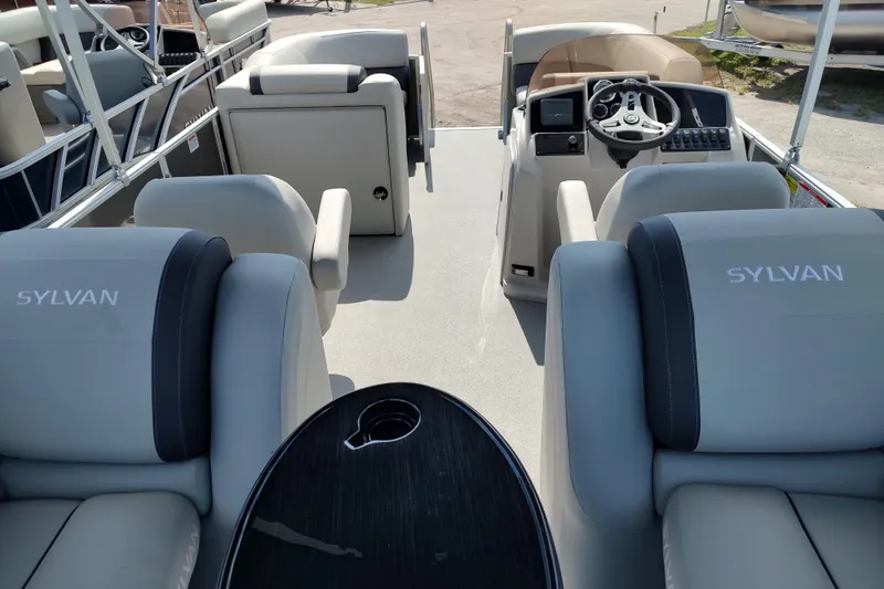 Slide: The Image of 2025 Sylvan Mirage 822 LZ pontoon boat interior with plush seating and modern helm. - 15