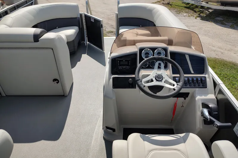 Slide: The Image of 2025 Sylvan Mirage 822 LZ boat interior with steering console and seating area. - 16