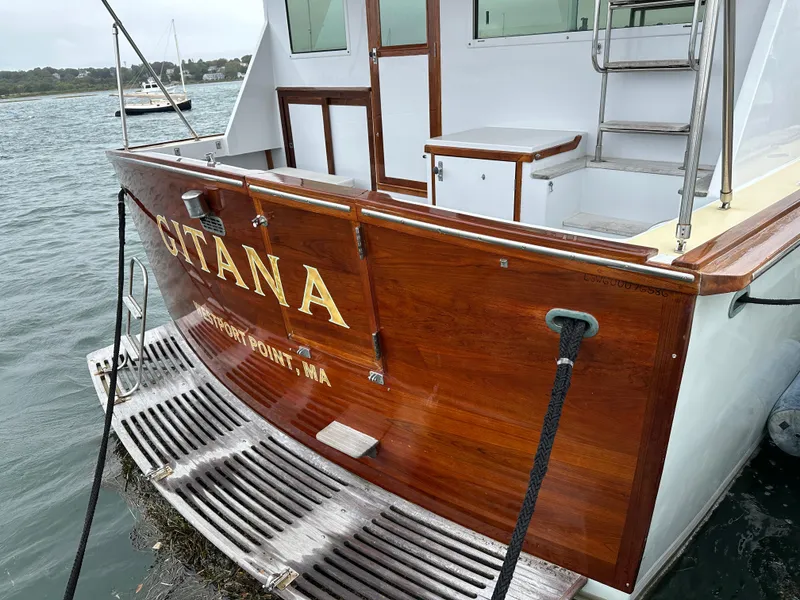 Slide: The Image of 1986 Wilbur Hunt Yachts boat with wooden finish, docked at a marina. - 11