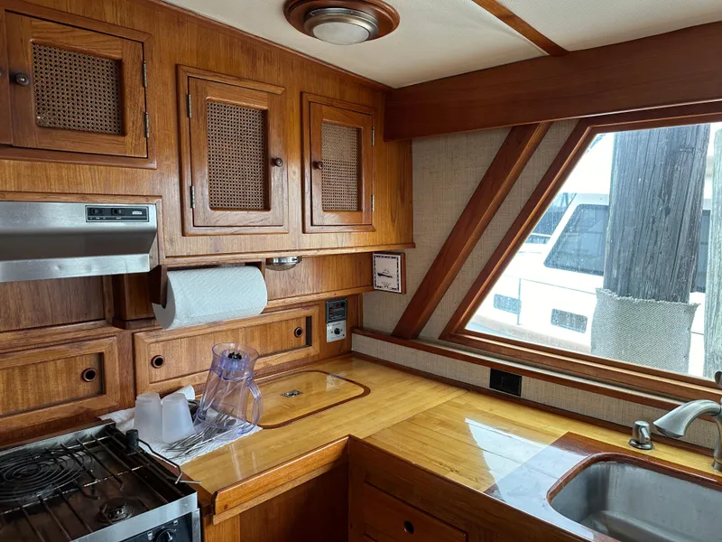 Slide: The Image of 1986 Wilbur Hunt Yachts kitchen interior with wooden cabinetry and modern appliances. - 18