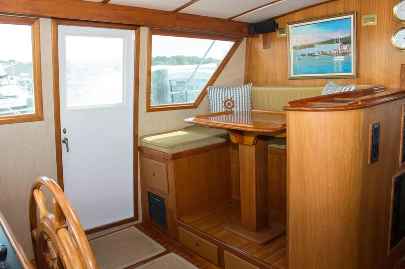 Slide: The Image of Interior of 1986 Wilbur Hunt Yachts, featuring wooden seating and nautical decor. - 24