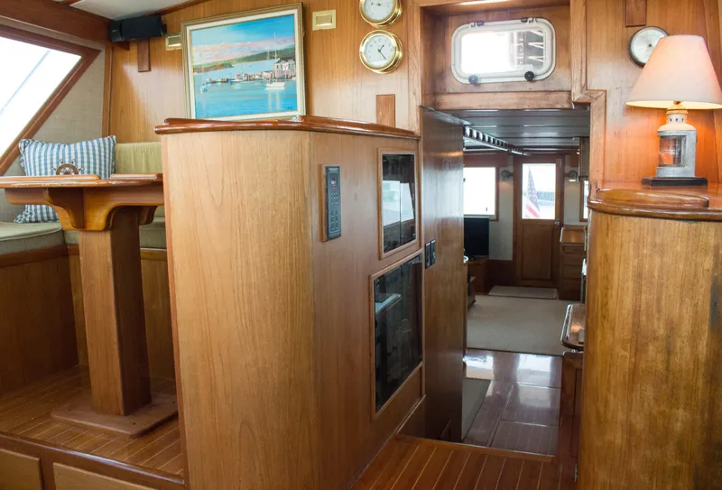 Slide: The Image of 1986 Wilbur Hunt Yachts interior with wood paneling, nautical decor, and cozy seating area. - 25