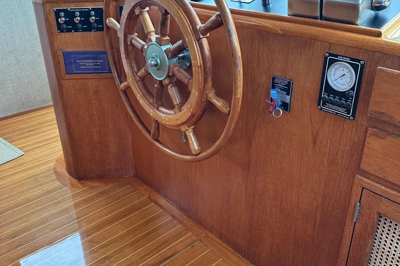 Slide: The Image of Wooden helm of 1986 Wilbur Hunt Yachts, featuring classic nautical design and polished finish. - 26