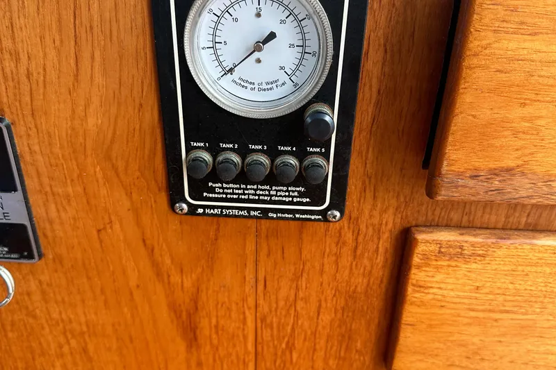 Slide: The Image of Fuel gauge panel on 1986 Wilbur Hunt Yachts, featuring tank indicators and wooden finish. - 31
