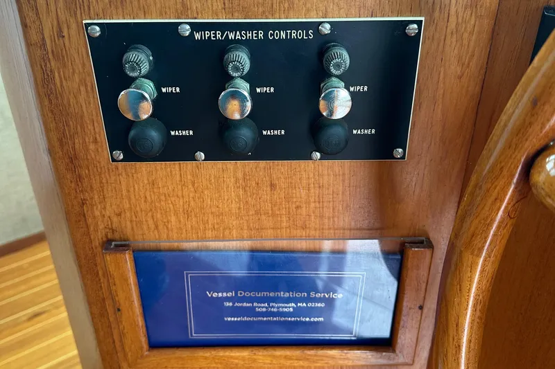 Slide: The Image of Wiper and washer controls on 1986 Wilbur Hunt Yachts dashboard, with vessel documentation service plaque. - 32