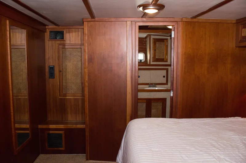 Slide: The Image of 1986 Wilbur Hunt Yachts interior with wooden cabinetry and cozy bedroom. - 35