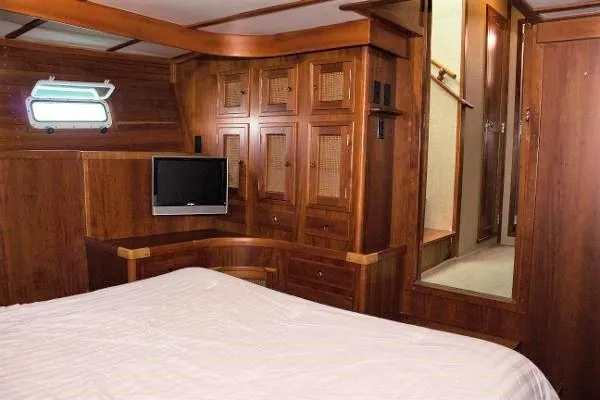 Slide: The Image of Luxurious 1986 Wilbur Hunt Yachts cabin interior with wood paneling and cozy bed. - 37