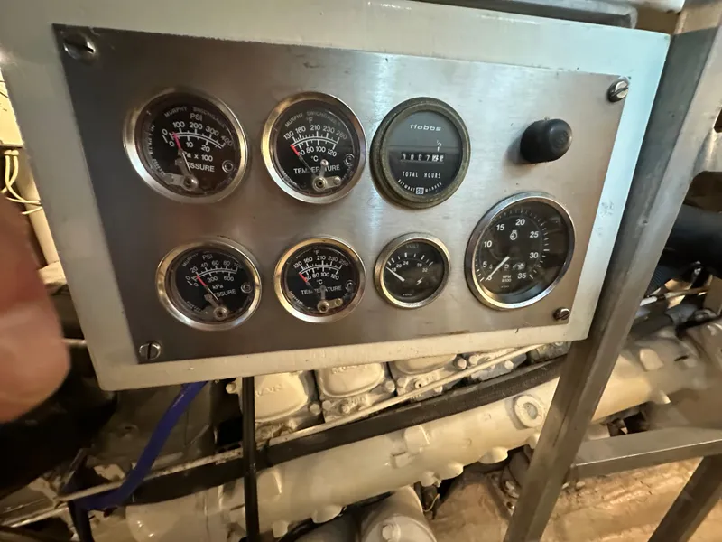 Slide: The Image of Control panel of a 1986 Wilbur Hunt Yachts engine with multiple gauges. - 47