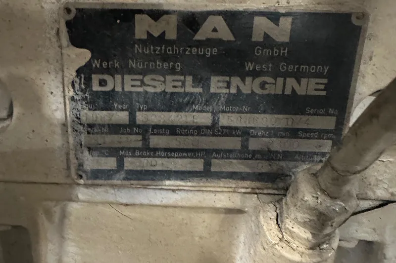Slide: The Image of 1986 MAN diesel engine plate on Wilbur Hunt Yachts, showing specifications and origin details. - 48