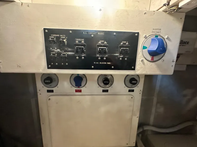Slide: The Image of Electrical panel of a 1986 Wilbur Hunt Yachts, featuring circuit breakers and inverter disconnect. - 49