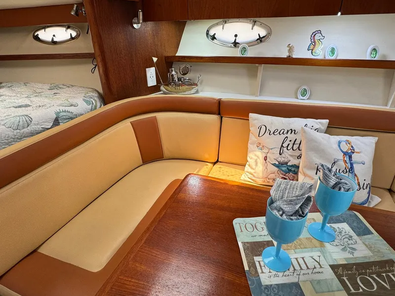 Slide: The Image of Cozy interior of 2000 Tiara Yachts 3100 Open with nautical decor and seating area. - 11