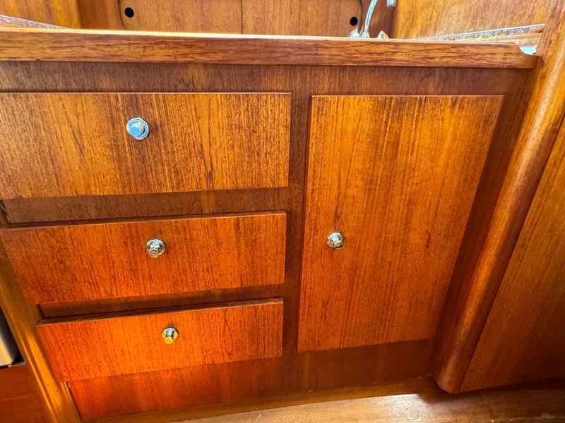 Slide: The Image of Wooden cabinetry inside a 2000 Tiara Yachts 3100 Open boat. - 14