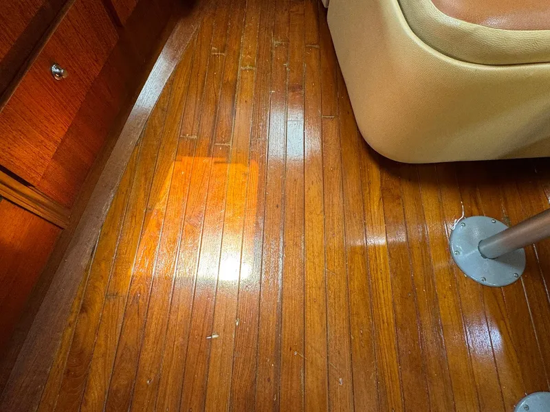 Slide: The Image of Polished wooden floor inside a 2000 Tiara Yachts 3100 Open boat cabin. - 15