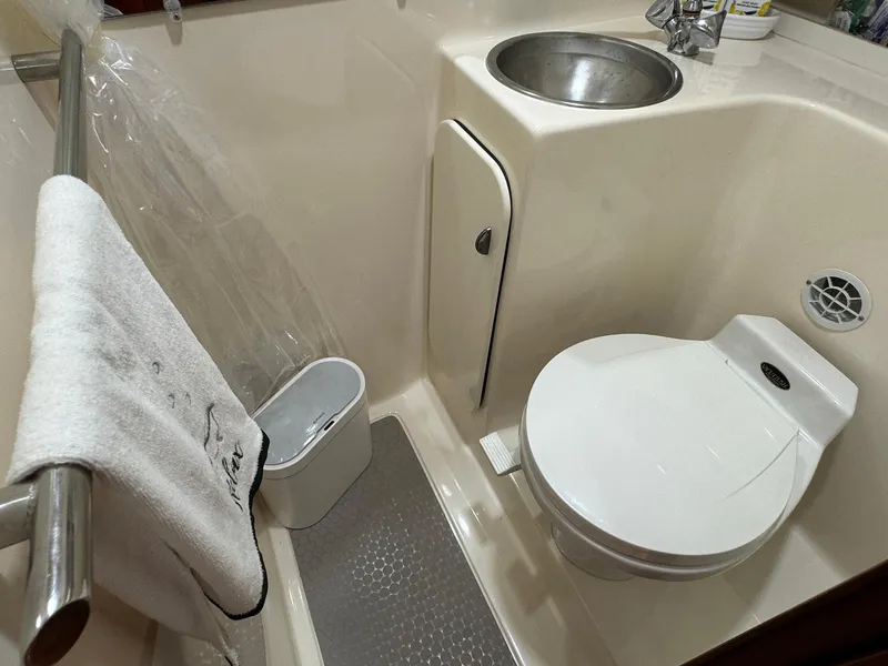 Slide: The Image of Compact bathroom in 2000 Tiara Yachts 3100 Open, featuring toilet and sink. - 20