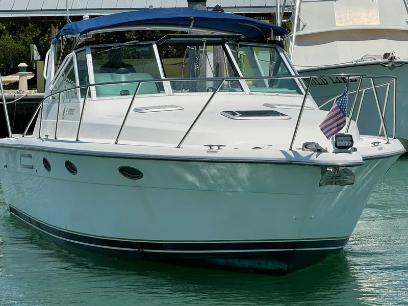 Slide: The Image of 2000 Tiara Yachts 3100 Open boat docked in marina, American flag displayed. - 22