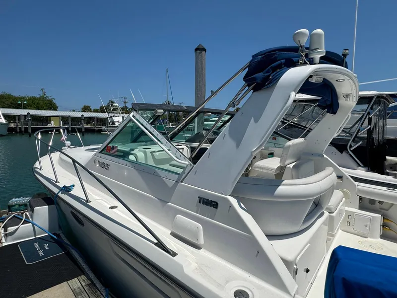 Slide: The Image of 2000 Tiara Yachts 3100 Open docked at marina under clear blue sky. - 33