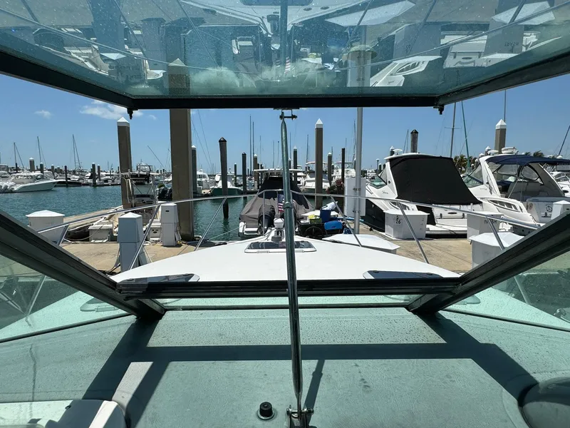 Slide: The Image of View from 2000 Tiara Yachts 3100 Open, docked at marina with other boats. - 35