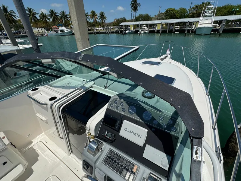 Slide: The Image of 2000 Tiara Yachts 3100 Open cockpit with Garmin navigation, docked in a marina. - 36