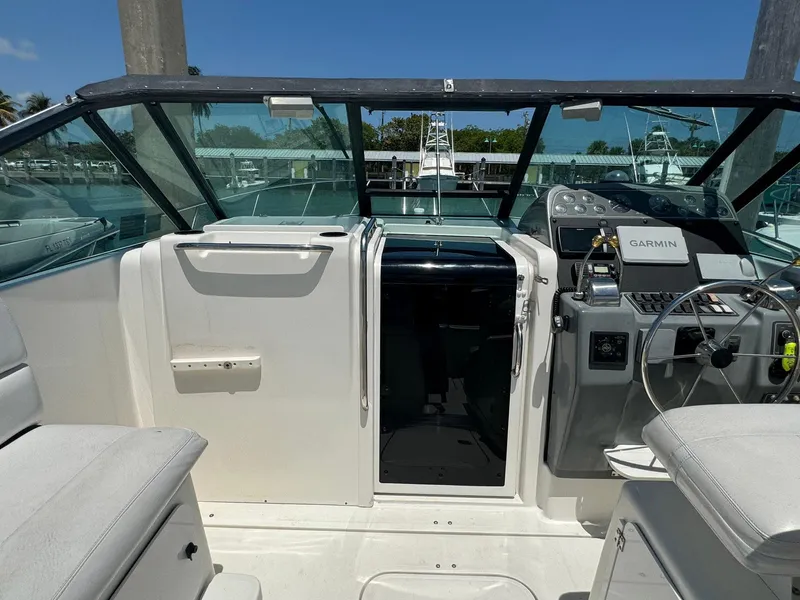 Slide: The Image of 2000 Tiara Yachts 3100 Open cockpit with steering wheel and Garmin navigation system. - 37