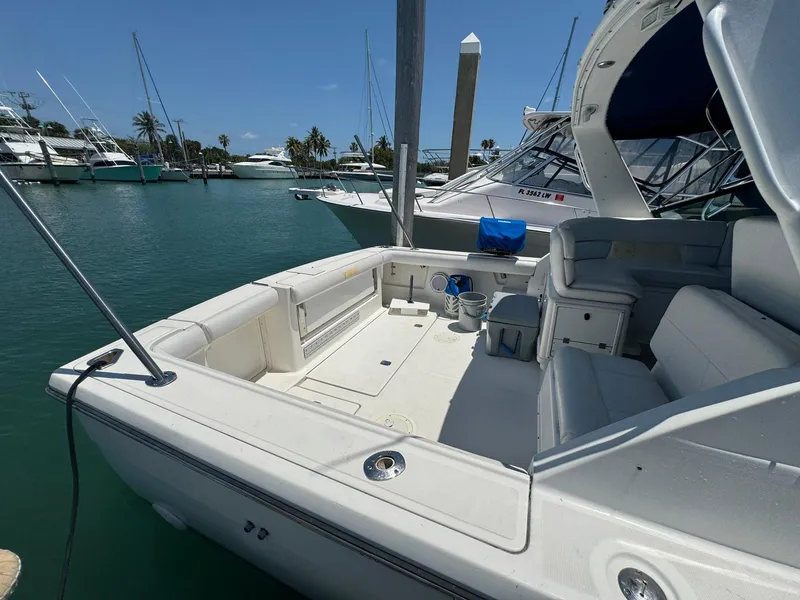 Slide: The Image of Tiara Yachts 3100 Open 2000 model docked in a marina, featuring spacious deck area. - 46