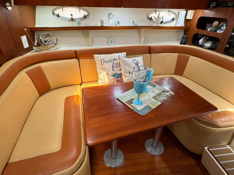Slide: The Image of Cozy interior of 2000 Tiara Yachts 3100 Open with cushioned seating and wooden table. - 7
