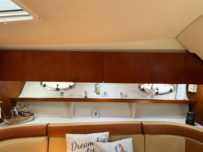 Slide: The Image of Interior of 2000 Tiara Yachts 3100 Open with wooden cabinets and decorative pillows. - 8