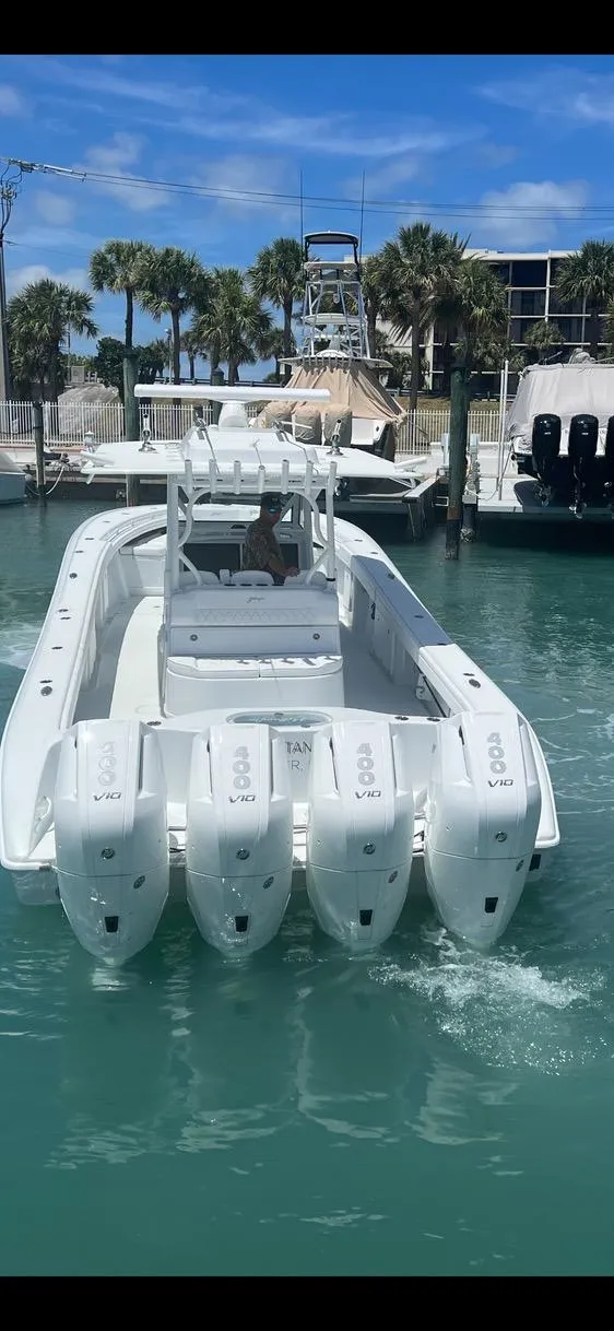 Slide: The Image of 2023 Yellowfin 39 Offshore boat with four engines in a marina setting. - 10