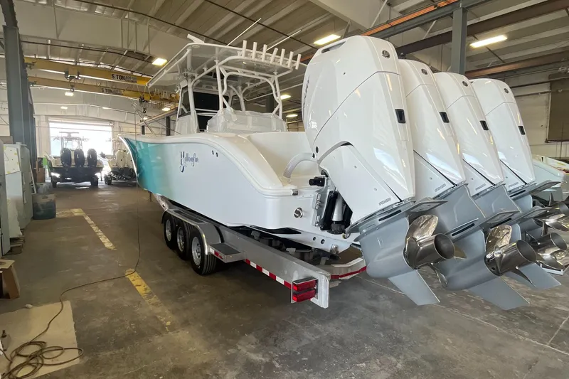 Slide: The Image of 2023 Yellowfin 39 Offshore boat with multiple engines in a warehouse setting. - 3
