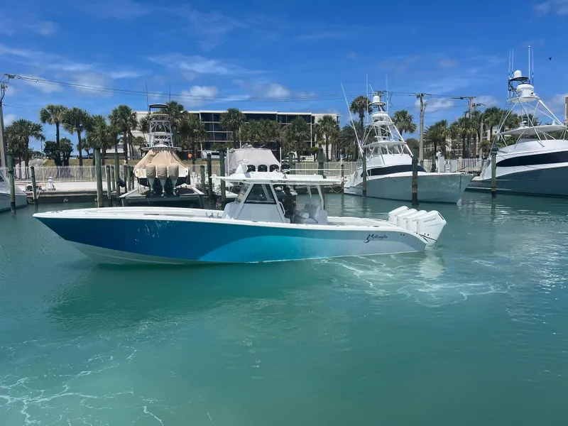 Slide: The Image of 2023 Yellowfin 39 Offshore boat in marina, clear blue water, sunny day. - 5