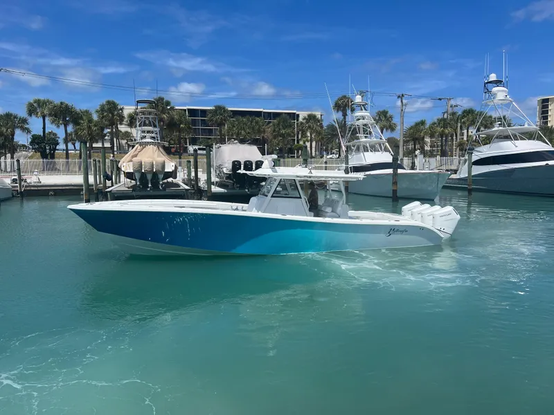 Slide: The Image of 2023 Yellowfin 39 Offshore boat in a marina with clear blue water. - 6