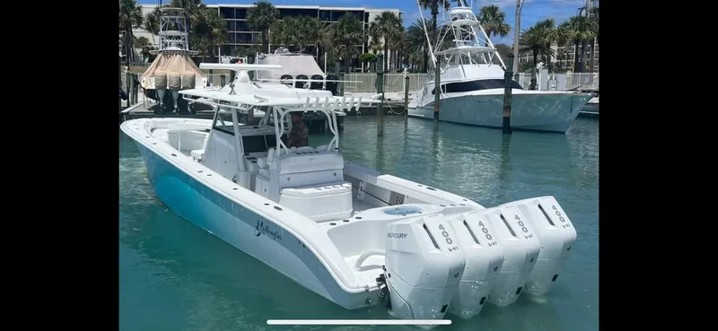 Slide: The Image of 2023 Yellowfin 39 Offshore boat with triple Mercury engines docked in a marina. - 8