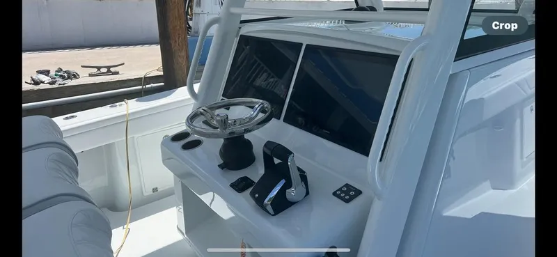 Slide: The Image of 2023 Yellowfin 39 Offshore boat helm with steering wheel and controls. - 9