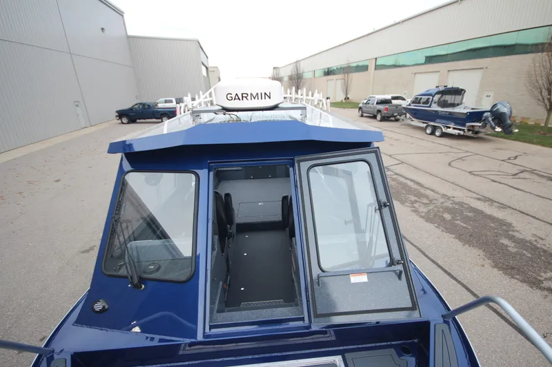 Slide: The Image of 2025 Weldcraft 240 Ocean King boat with Garmin equipment, parked outdoors. - 11