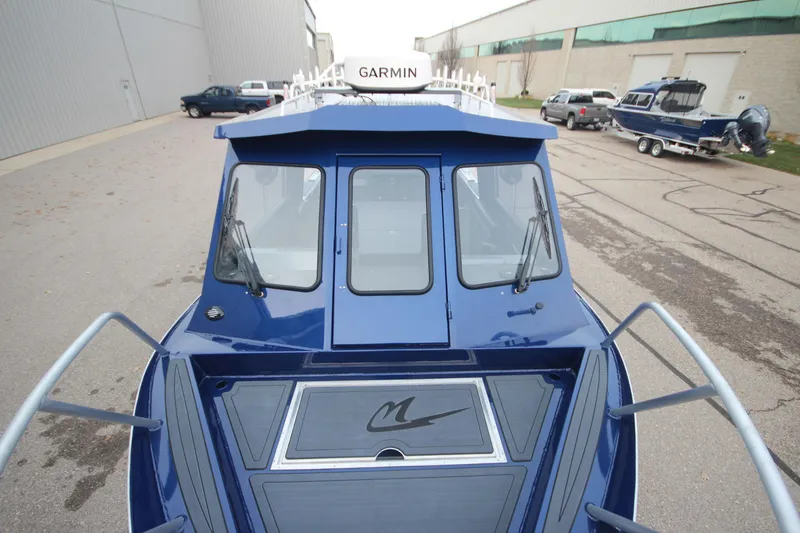 Slide: The Image of 2025 Weldcraft 240 Ocean King boat, blue exterior, Garmin equipment, parked outdoors. - 12