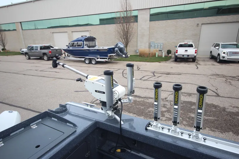 Slide: The Image of 2025 Weldcraft 240 Ocean King boat with fishing gear, parked outside a warehouse. - 16