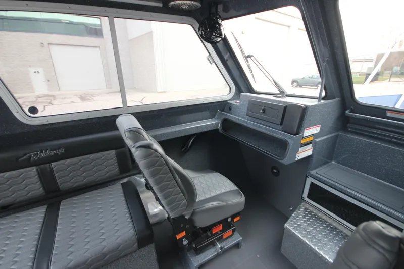 Slide: The Image of Interior of 2025 Weldcraft 240 Ocean King boat, featuring modern seating and dashboard. - 32