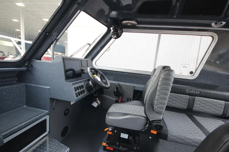 Slide: The Image of Interior of 2025 Weldcraft 240 Ocean King boat, featuring modern helm and seating. - 34