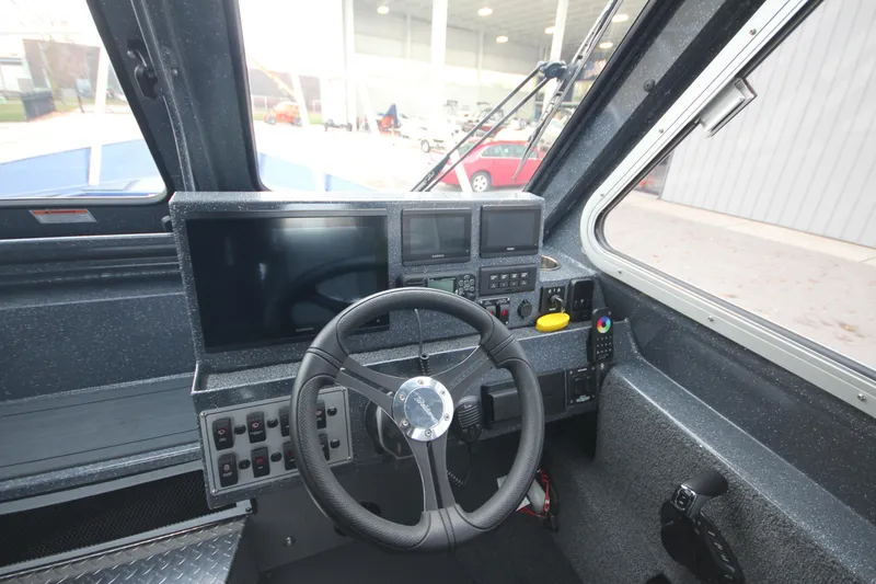 Slide: The Image of 2025 Weldcraft 240 Ocean King boat cockpit with advanced navigation controls and steering wheel. - 35