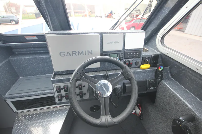 Slide: The Image of 2025 Weldcraft 240 Ocean King cockpit with Garmin navigation system and steering wheel. - 36